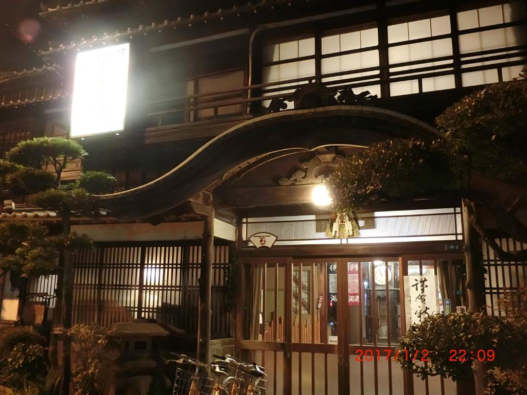 a building with a gate with a light on it at Hoshidekan in Ise