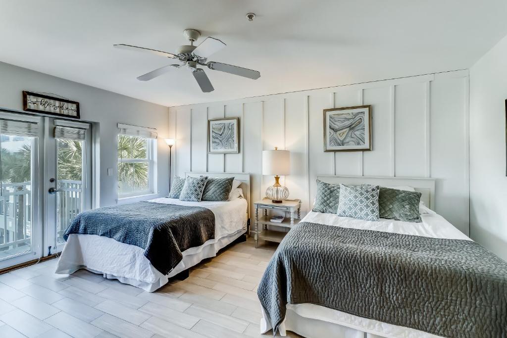 a bedroom with two beds and a ceiling fan at Inn at Gulf Place in Santa Rosa Beach