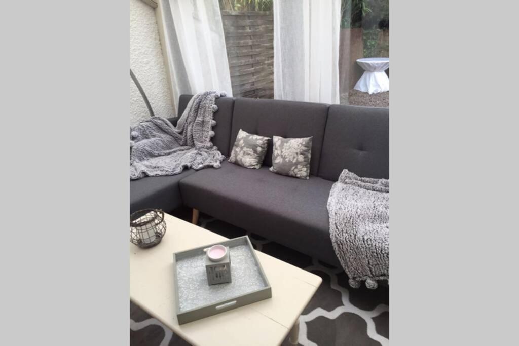 a living room with a couch and a table at Gîte Ste Cécile plage in Camiers