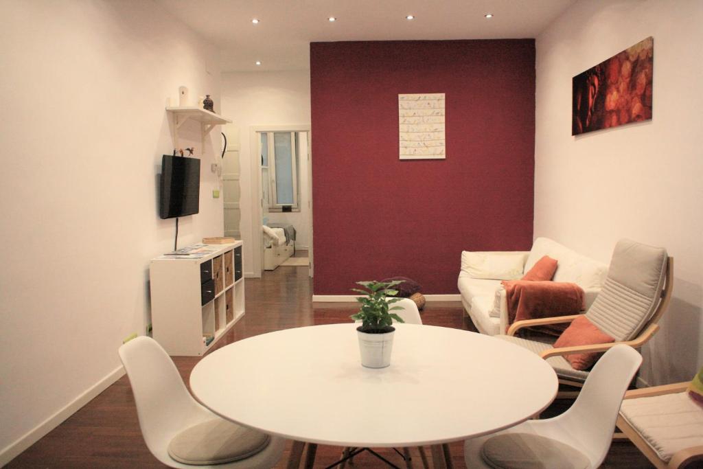 a living room with a white table and chairs at Apartamento Jare in Bilbao
