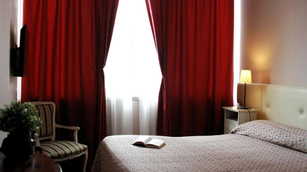 A bed or beds in a room at Ankon Hotel