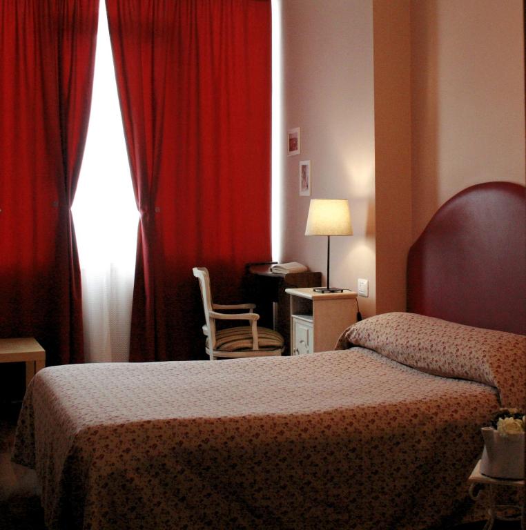 A bed or beds in a room at Ankon Hotel