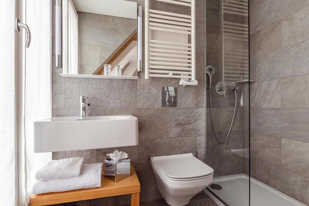 a bathroom with a sink and a toilet and a mirror at 9Hotel Republique in Paris