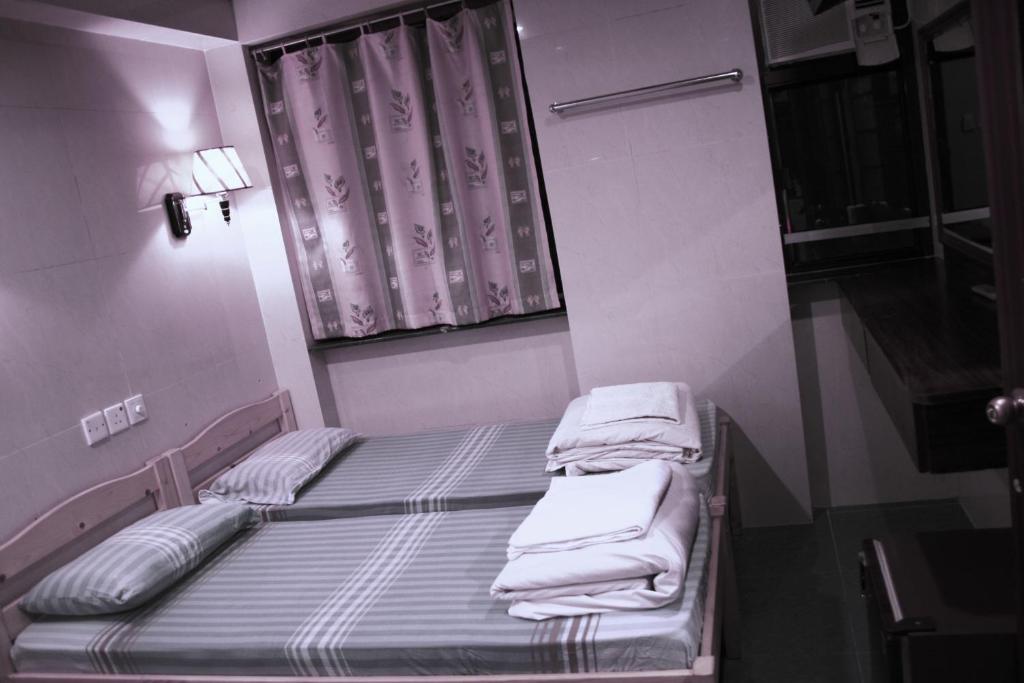 Postel nebo postele na pokoji v ubytování Kowloon YOUTH Village Tsim Sha Tsui 九龙青年公寓