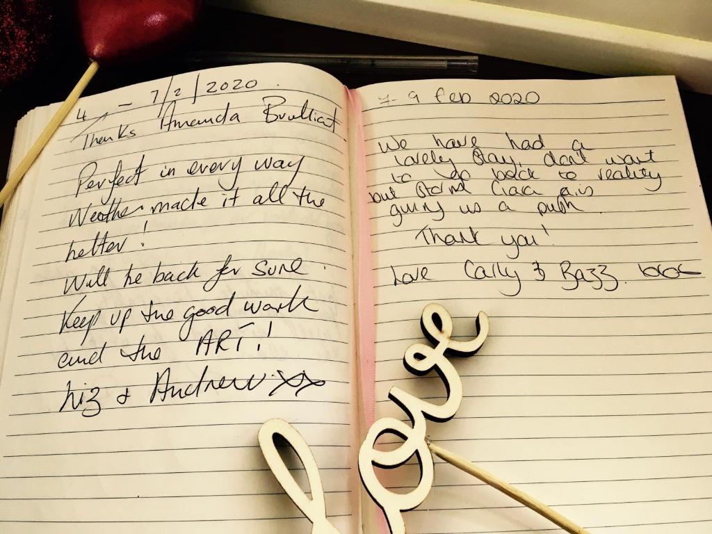 an open book with handwriting and a pair of scissors at Passengers House in Whitstable