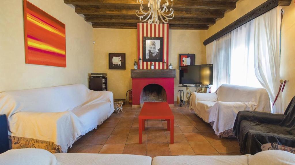 a living room with two couches and a fireplace at Casa Virgen del Carmen (VUT) in La Mata