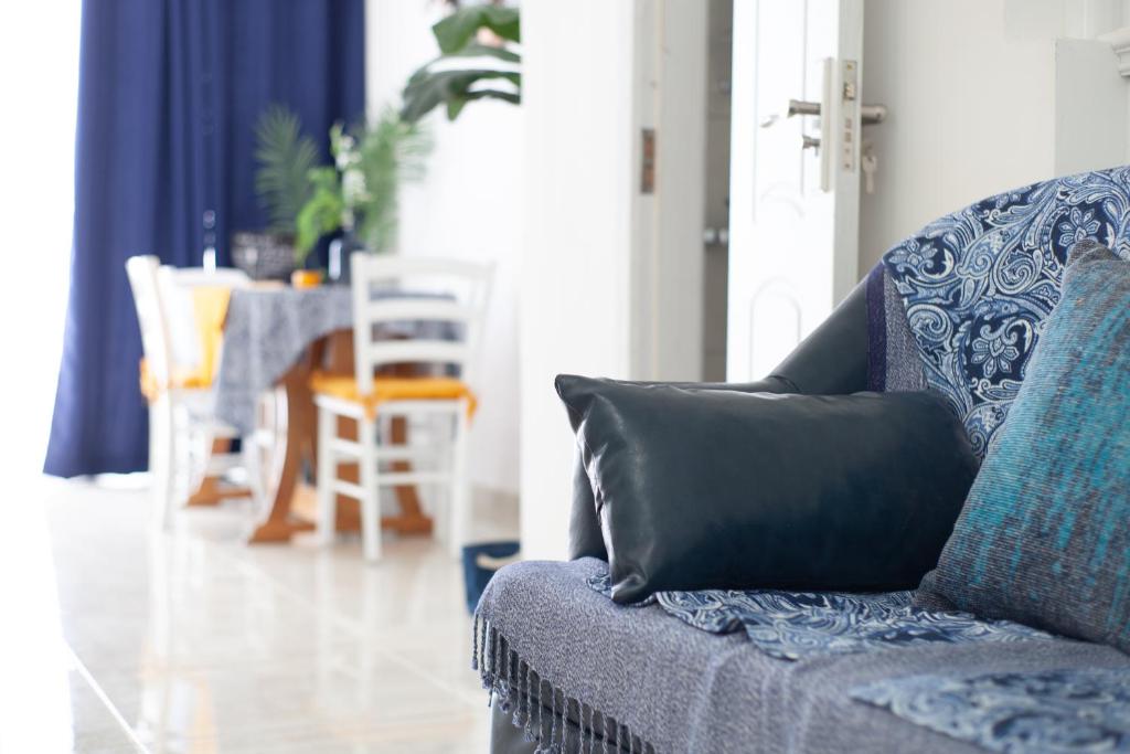 a blue couch with a pillow on it in a living room at Violetta in Birżebbuġa