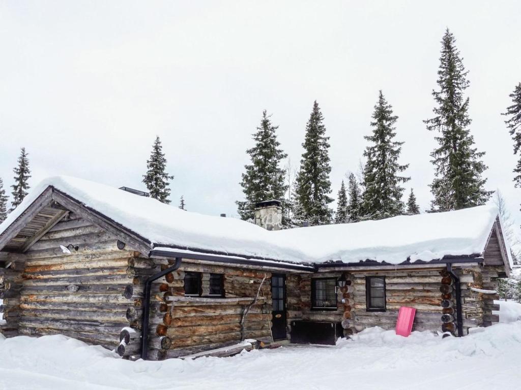 a log cabin with snow on the roof at Holiday Home Hopukka a2 by Interhome in Luosto