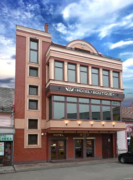 a hotel building with a sign on top of it at Hotel " BOUTIQUE " in Uzhhorod