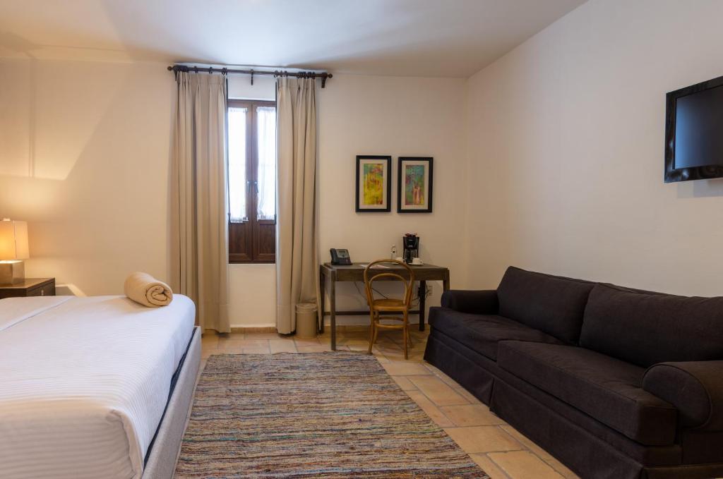 Postel nebo postele na pokoji v ubytování Hotel Hacienda San Cristóbal