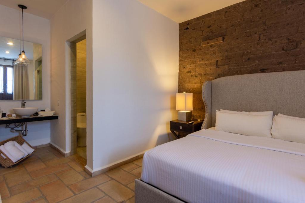 Postel nebo postele na pokoji v ubytování Hotel Hacienda San Cristóbal