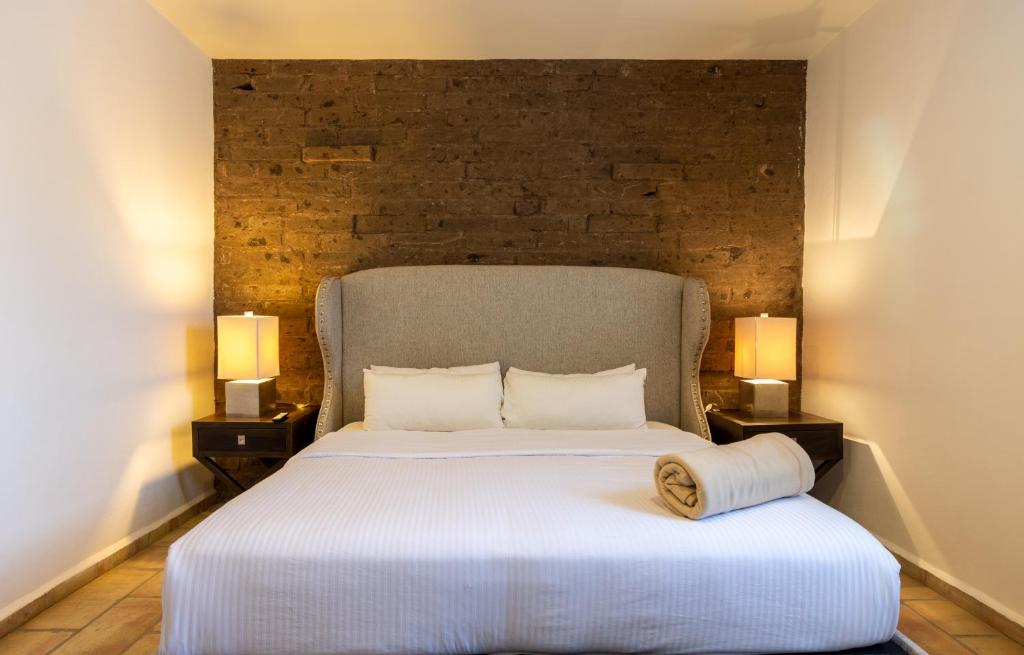 Postel nebo postele na pokoji v ubytování Hotel Hacienda San Cristóbal
