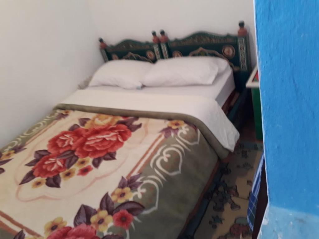 Una cama o camas en una habitación de Harmony Hotel