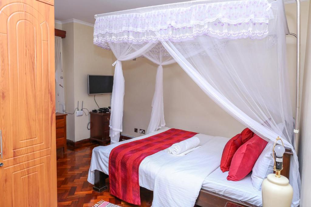 Postel nebo postele na pokoji v ubytování Orchid Homes, Gigiri