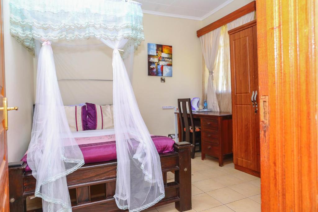 Postel nebo postele na pokoji v ubytování Orchid Homes, Gigiri