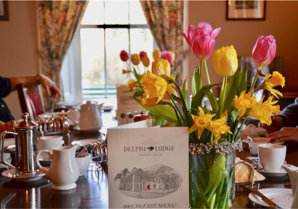 a vase filled with flowers sitting on a table at Delphi Lodge in Leenaun