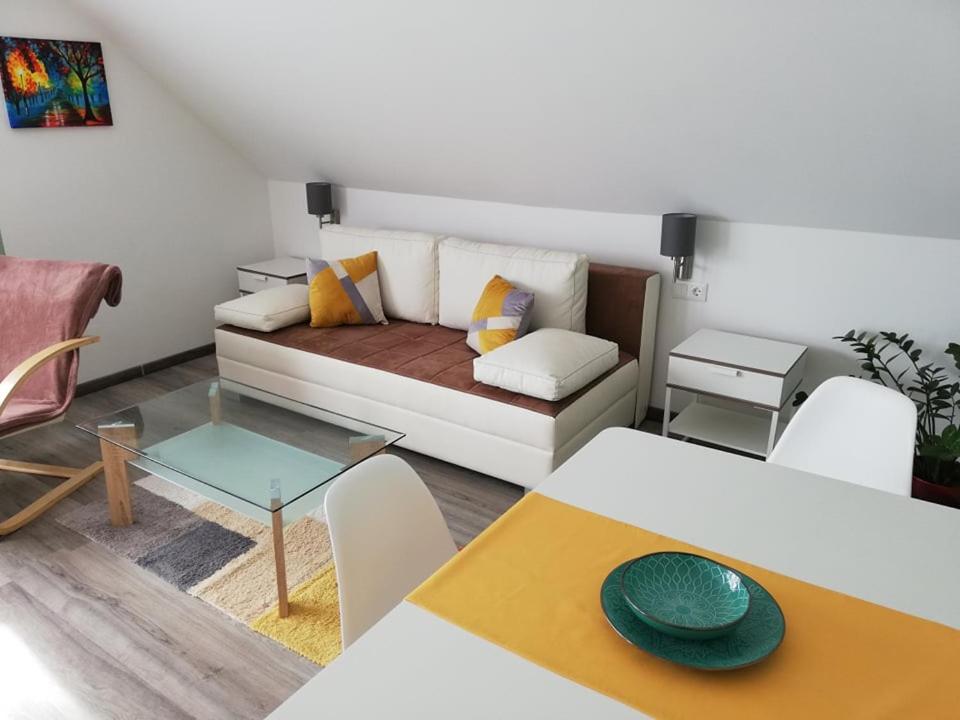 a living room with a couch and a table at Éva Apartman in Hévíz