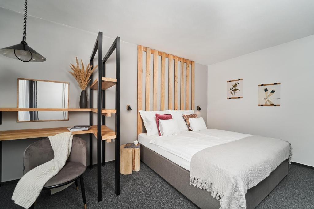 Postel nebo postele na pokoji v ubytování Hotel Arborétum
