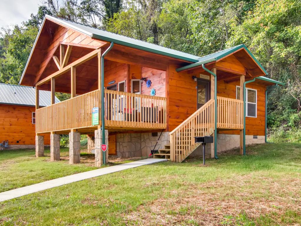 a log cabin with a large porch and a deck at River Getaway #2326 in Pigeon Forge