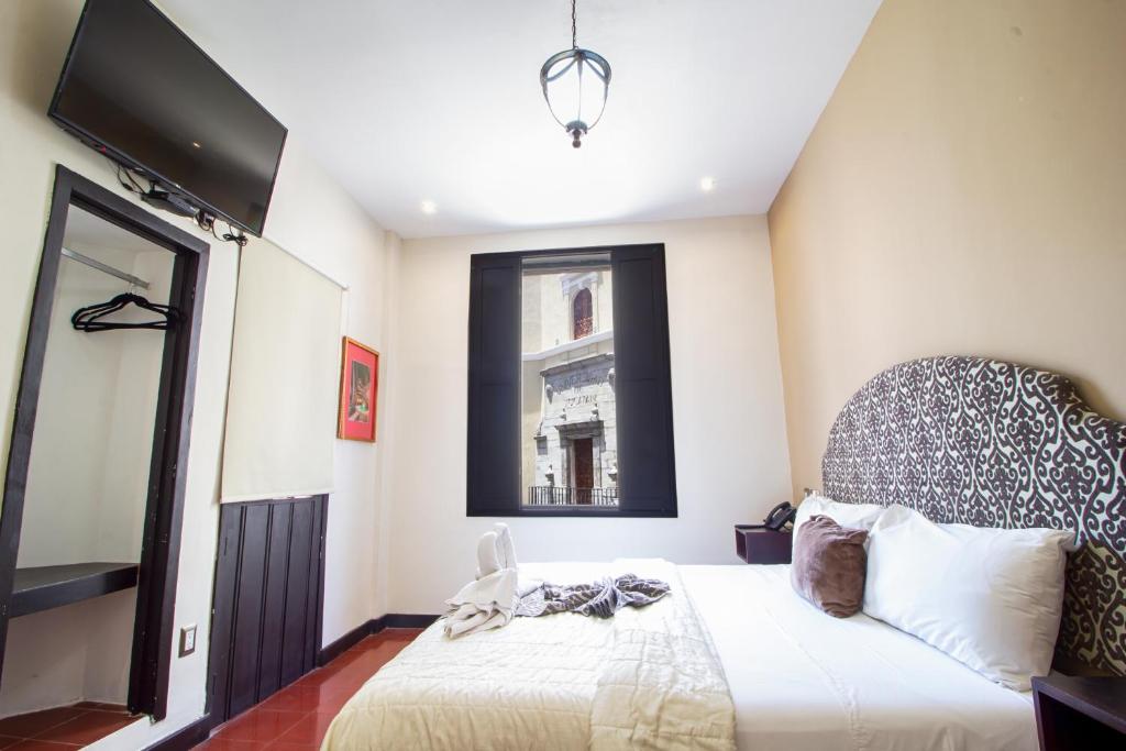 Postel nebo postele na pokoji v ubytování Hotel Merida