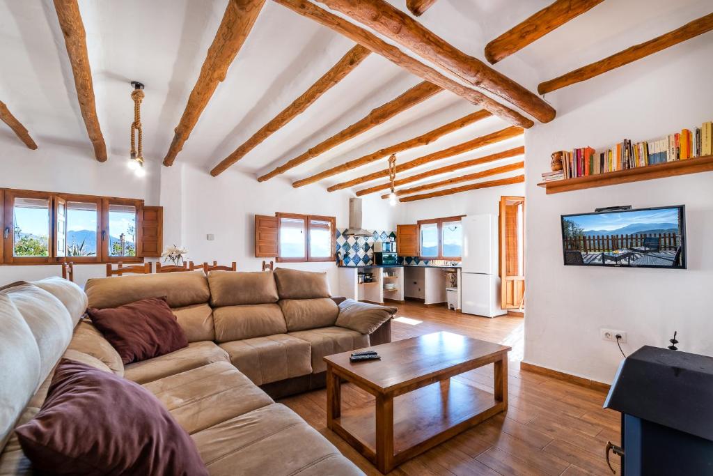 a living room with a couch and a table at Dreams Alpujarra in Pampaneira