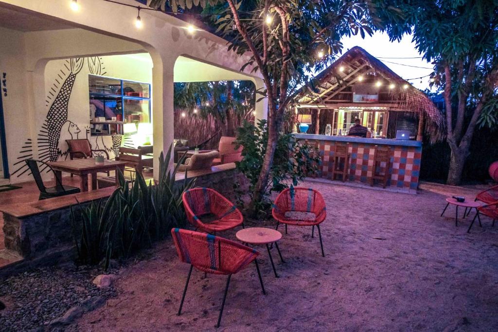 a group of chairs and tables in a patio at Todos Santos Hostel super fast and stable satellite wifi in Todos Santos