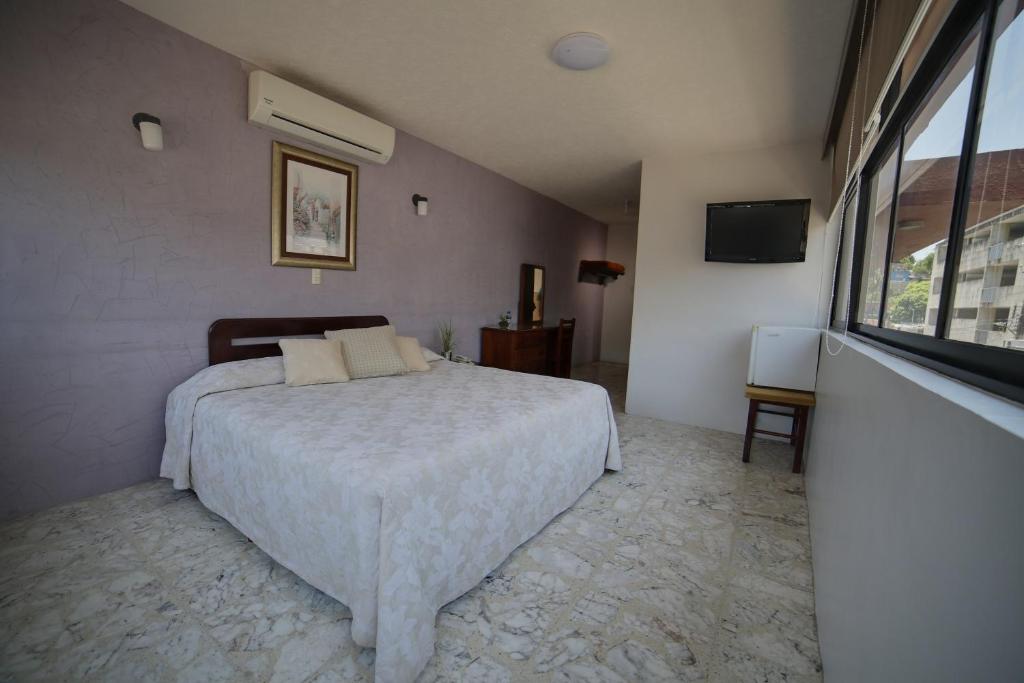 Postel nebo postele na pokoji v ubytování Hotel Plaza