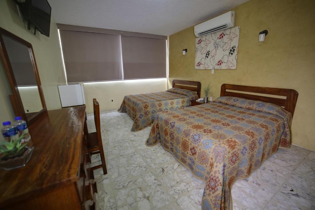 Postel nebo postele na pokoji v ubytování Hotel Plaza