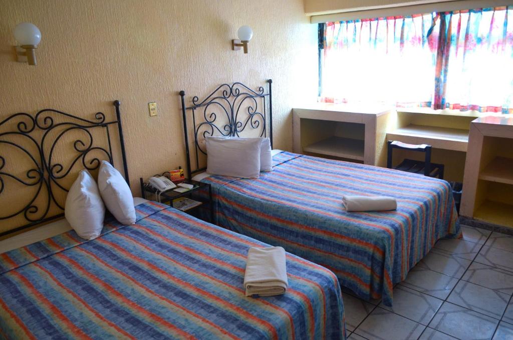 Postel nebo postele na pokoji v ubytování Hotel Terrasol