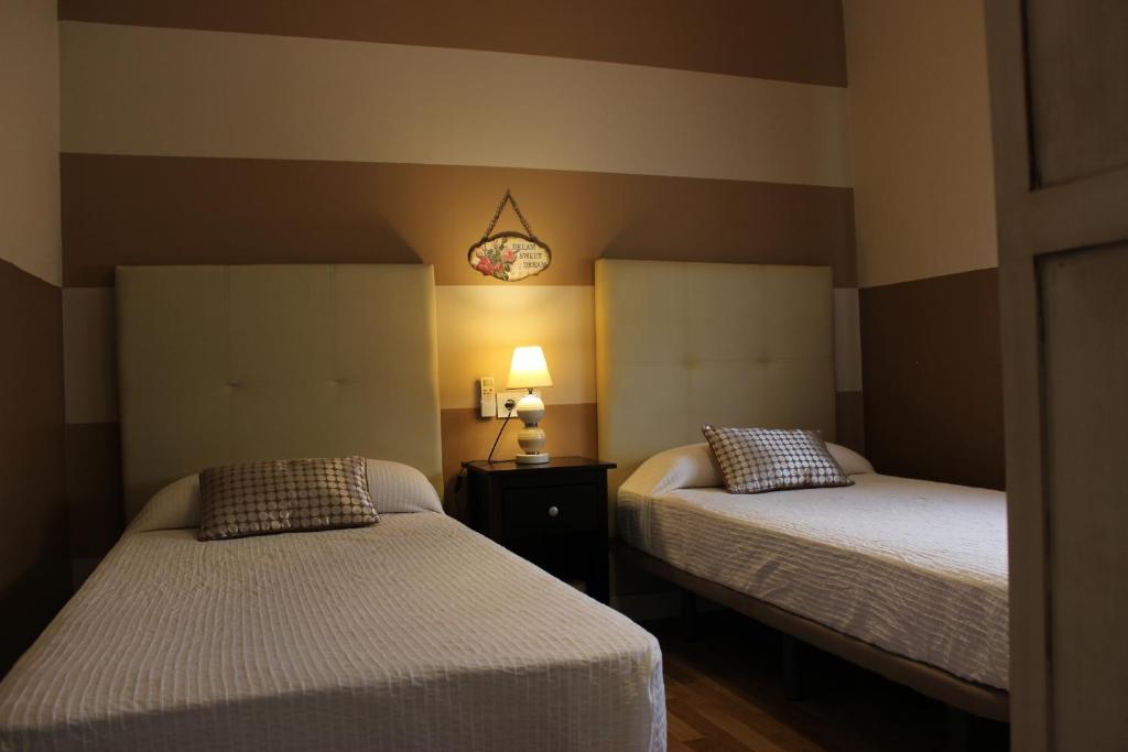 Posteľ alebo postele v izbe v ubytovaní Apartamentos Nundinae