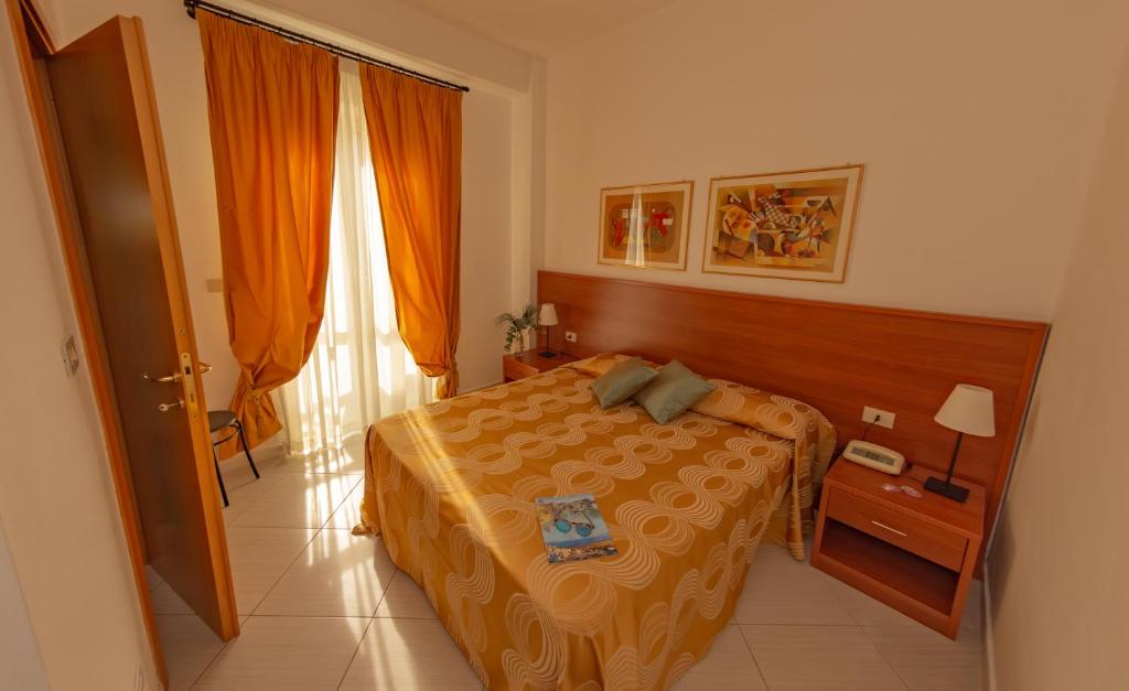 a hotel room with a bed and a window at Hotel Solaria in Rodi Garganico