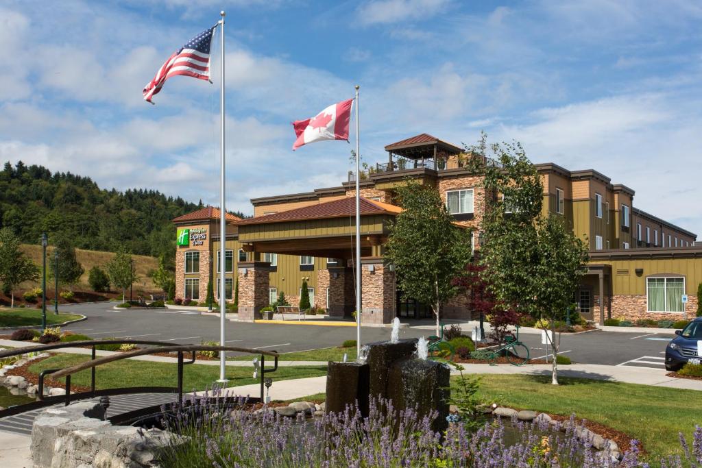 a large building with a flag on top of it at Holiday Inn Express Hotel & Suites North Sequim, an IHG Hotel in Sequim