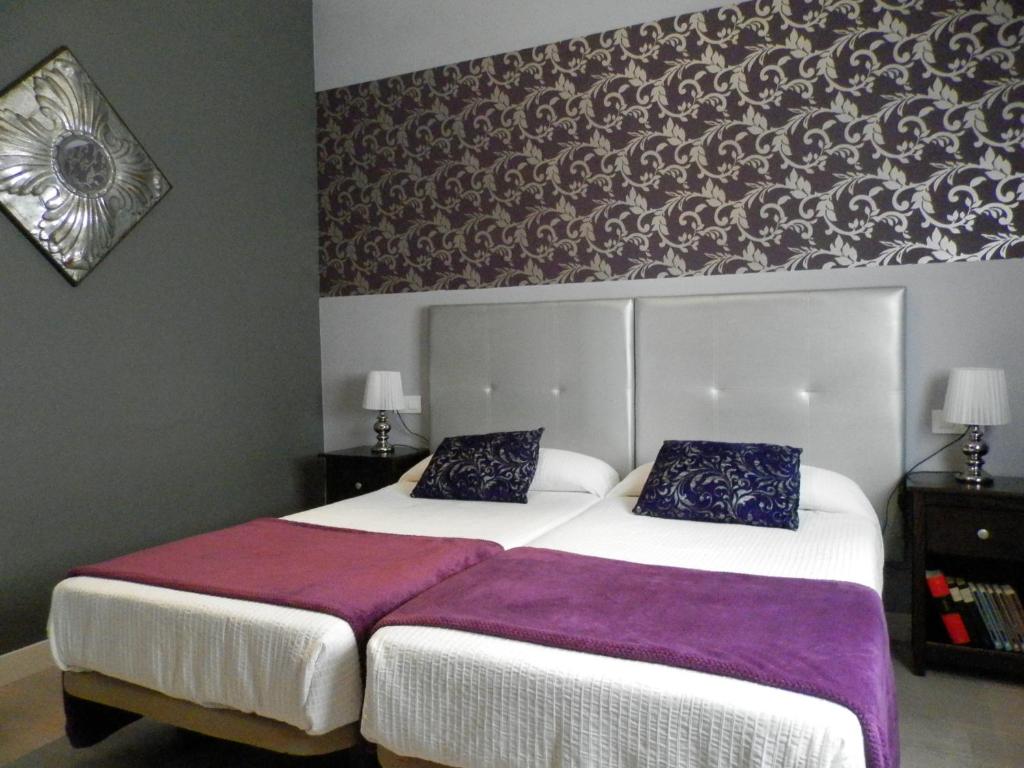 Posteľ alebo postele v izbe v ubytovaní Apartamentos Nundinae