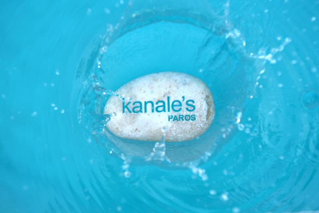 a rock in the water with the word karma on it at Kanale's Rooms & Suites in Naousa