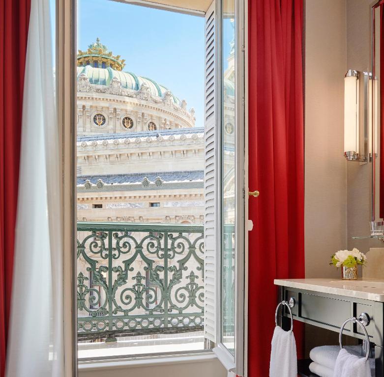 a bathroom with a window with a view of a building at InterContinental Paris Le Grand by IHG in Paris