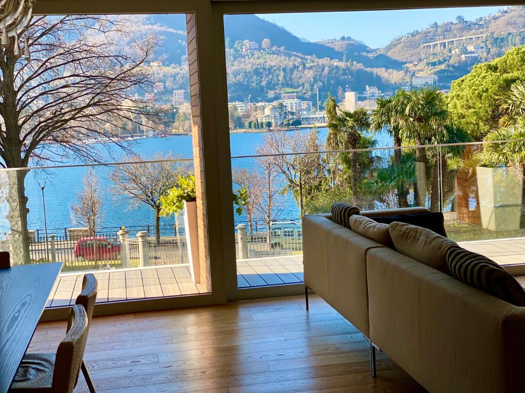 a living room with a couch and a large window at Villa Bianca in Como