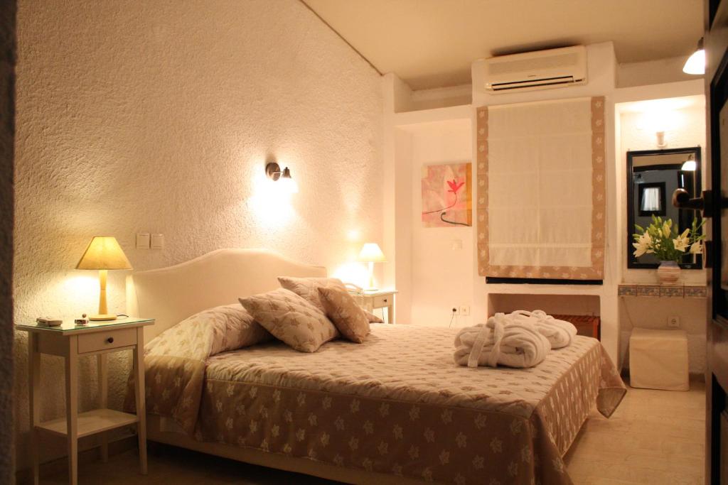 a bedroom with a bed with two towels on it at Mare Vista Hotel - Epaminondas in Batsi