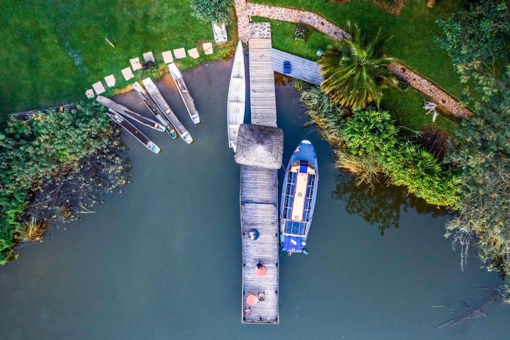 an overhead view of a dock with a boat in the water at Bunyonyi Overland Resort in Kabale