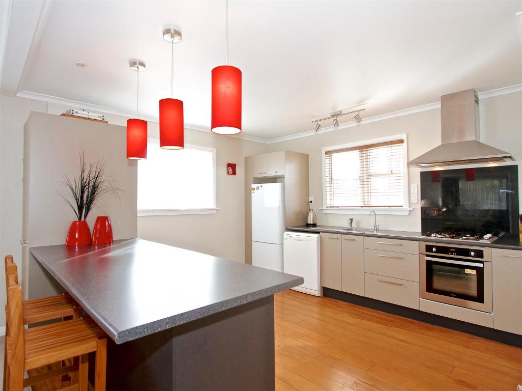 a kitchen with white cabinets and a counter top at Raetihi Cottage- Raetihi Holiday Home in Raetihi
