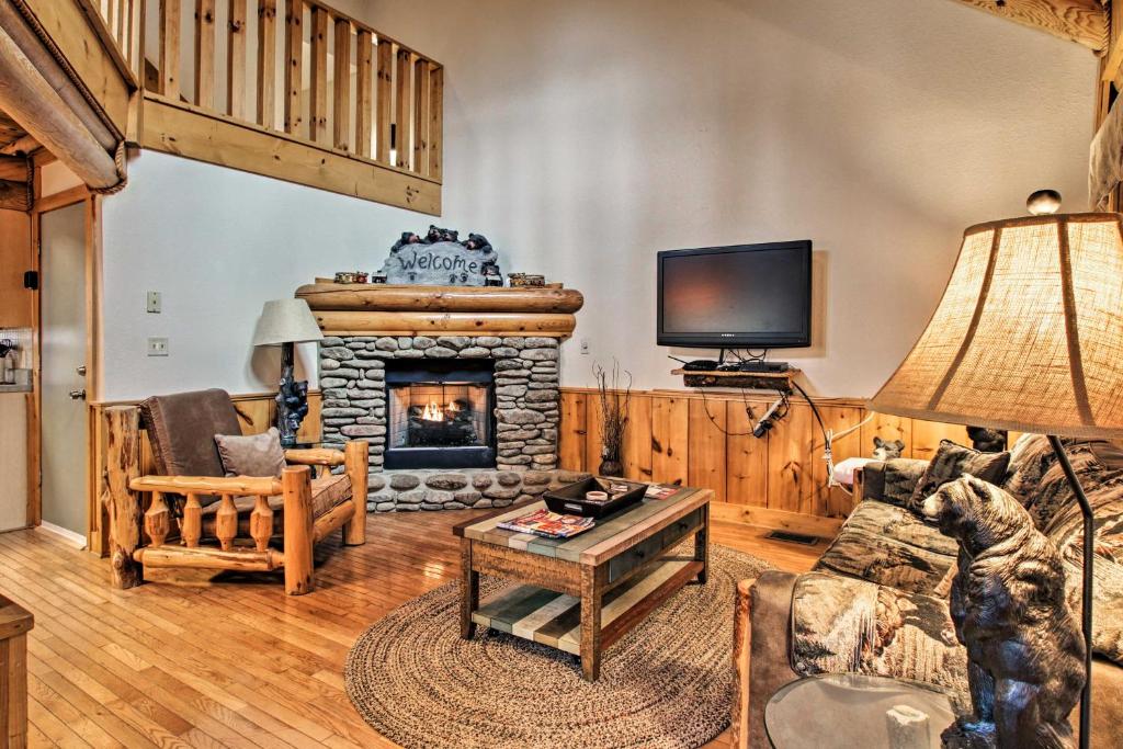 a living room with a fireplace and a tv at Pigeon Forge Vacation Rental 1 Mi to Dollywood in Pigeon Forge