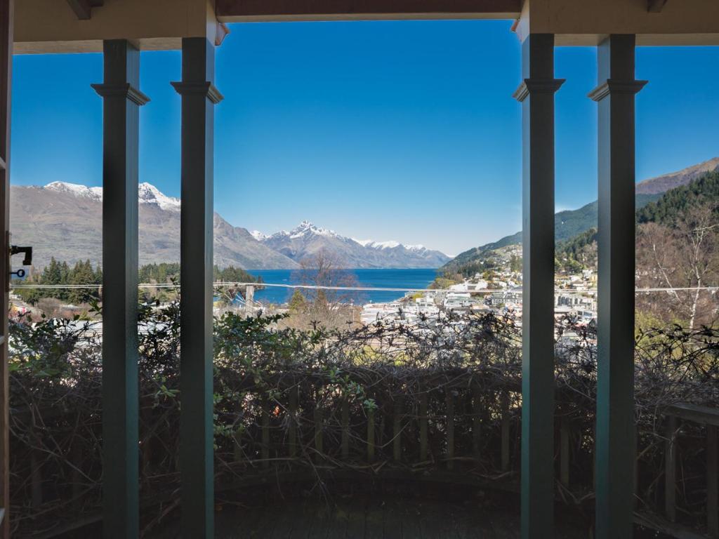 a view of a lake from the porch of a house at McAlister House - Queenstown Holiday Home in Queenstown