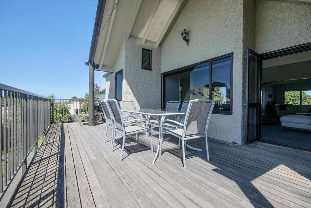 a patio with a table and chairs on a deck at Central City Gem - Napier Holiday Home in Napier