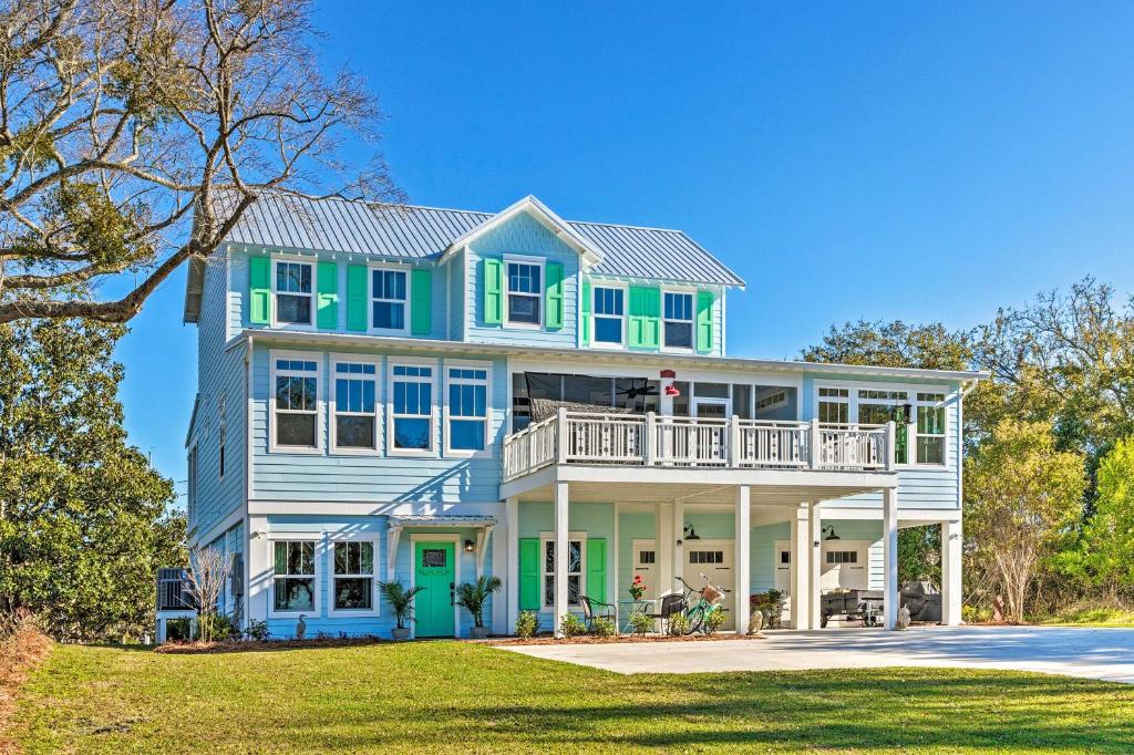 a large blue and green house with a porch at Harbor Oaks Haven Walk to Front Beach and Downtown! in Ocean Springs
