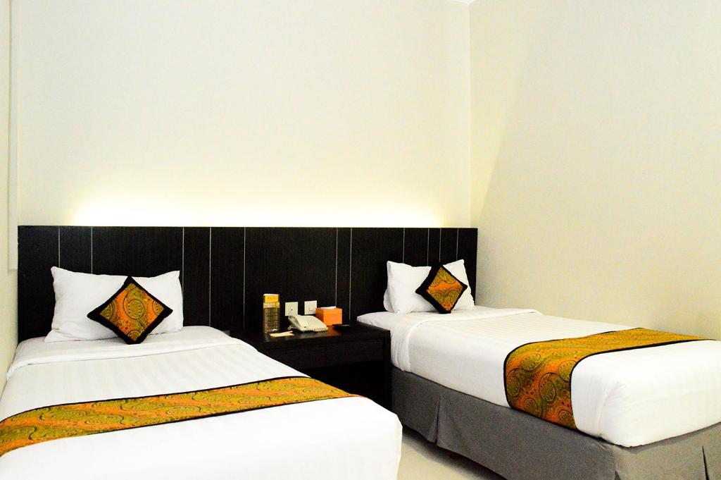 Postel nebo postele na pokoji v ubytování J Hotel - Bandara Soekarno Hatta