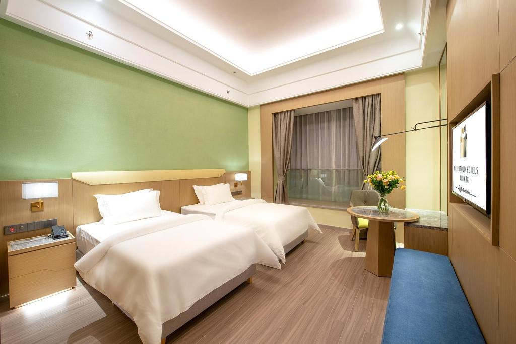 Postel nebo postele na pokoji v ubytování Metropolo Hotel-Guangzhou baiyunzhan jiangnan market canton fair phase free shuttle bus