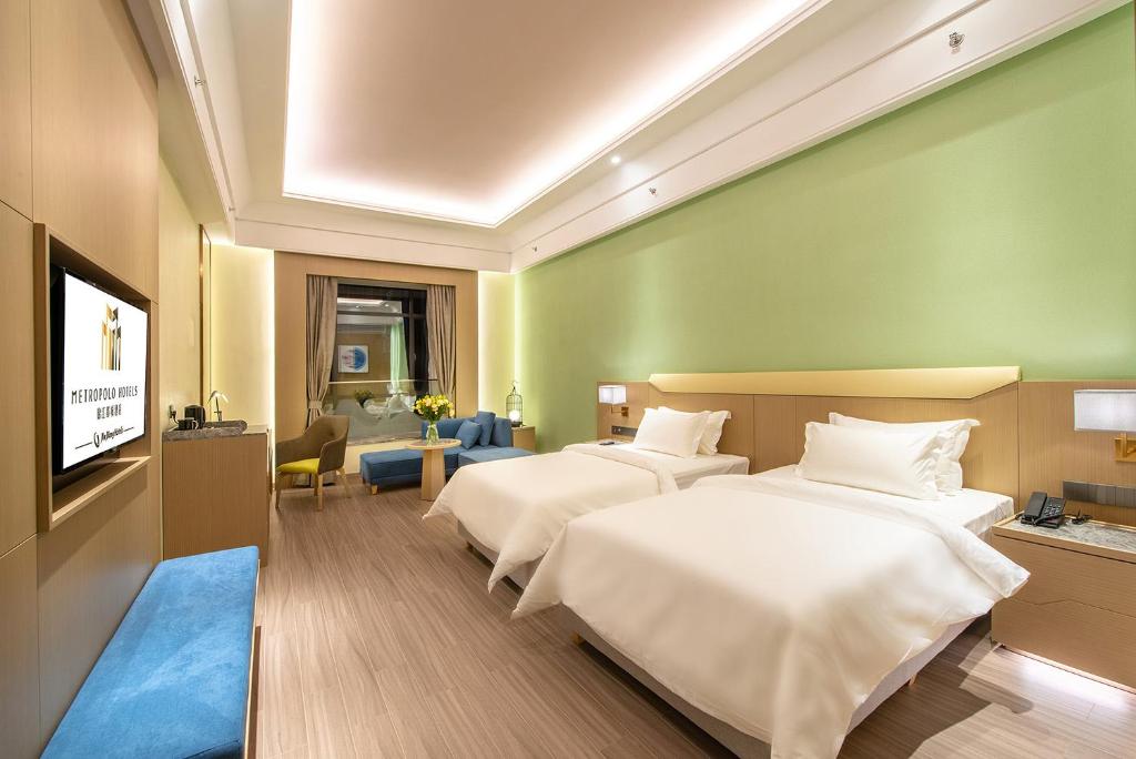Postel nebo postele na pokoji v ubytování Metropolo Hotel-Guangzhou baiyunzhan jiangnan market canton fair phase free shuttle bus