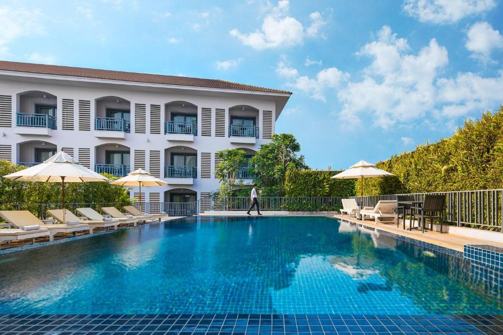 a hotel swimming pool in front of a building at Damrei Residence & Spa in Siem Reap