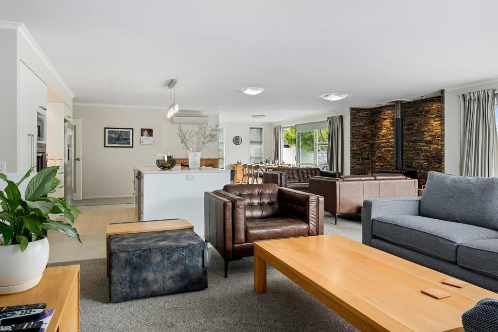 a living room with a couch and chairs and a table at Maison de Maude - Lake Hawea Holiday Home in Lake Hawea