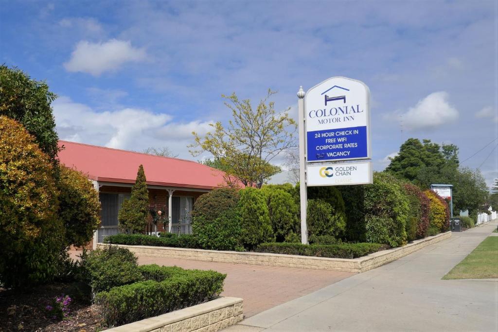 a sign in front of a building at Colonial Motor Inn Bairnsdale Golden Chain Property in Bairnsdale