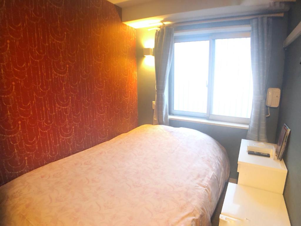 Postel nebo postele na pokoji v ubytování Tokyo Tourist Inn